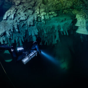 Sidemount diver near the guideline under overhanging bell formations, Cenote El Zapote, Quintana Roo, Mexico
