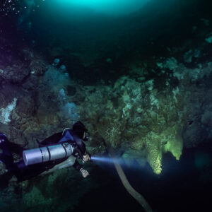 Sidemount diver below the cenote opening with turquoise light above, Cenote El Zapote, Quintana Roo, Mexico