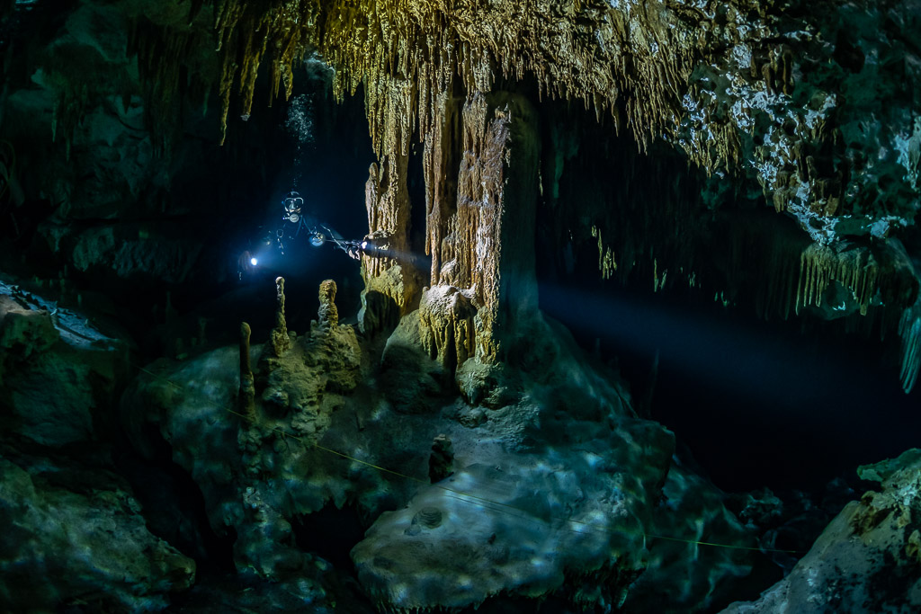 Deux plongeurs éclairant une salle de colonnes et de stalagmites, Quintana Roo, Mexique