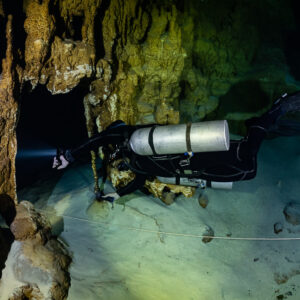 Sidemount diver close to a golden column above a guideline, Quintana Roo, Mexico