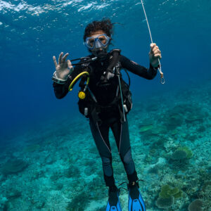Diver giving the OK sign while holding the buoy line, Komodo, Indonesia