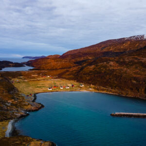 Aerial view of a sheltered bay with a pier and scattered houses, Seglvik, Troms, Norway