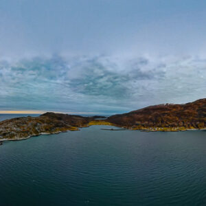Aerial panorama of a low island in the fjord at sunset, Seglvik, Troms, Norway