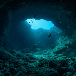 Cave interior with rocky floor and a bright opening, Flic-en-Flac, Mauritius