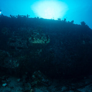 Diver above a wreck railing backlit by the sun, Maldives
