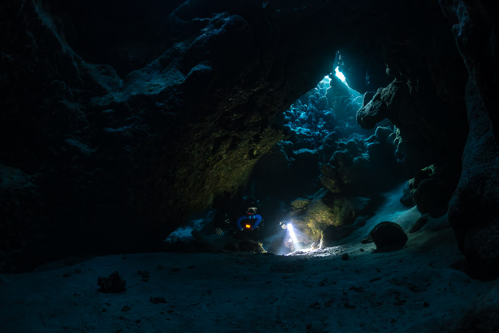 Small rebreather diver beneath a huge cave arch, Saint John's Cave, Red Sea, Egypt