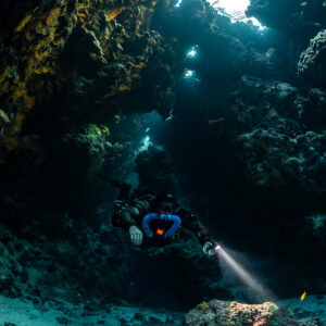 Rebreather diver below a large cave skylight, Saint John's Cave, Red Sea, Egypt