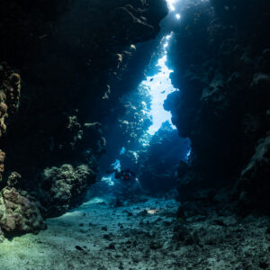 Light-filled cave fissure of Sha'ab Claudio, no diver, Sha'ab Claudio, Red Sea, Egypt