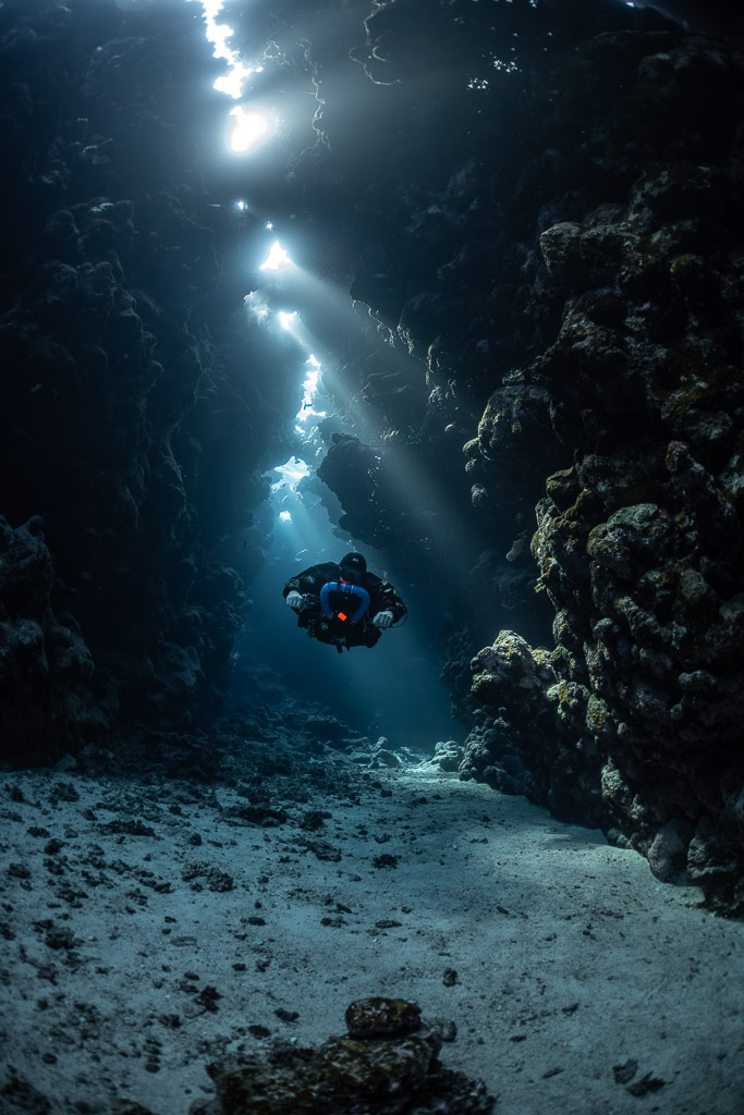Rebreather diver under a vertical line of sunbeams, Sha'ab Claudio, Red Sea, Egypt