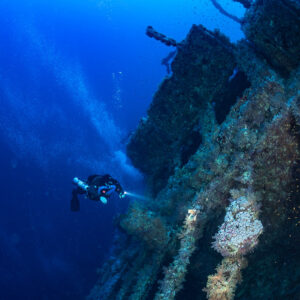 Rebreather diver alongside the Numidia wreck in deep blue water, Big Brother, Red Sea, Egypt
