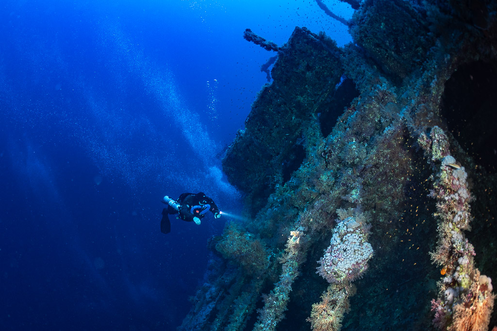 Rebreather diver alongside the Numidia wreck in deep blue water, Big Brother, Red Sea, Egypt