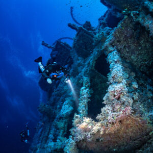 Rebreather diver among coral-covered frames of the Numidia wreck, Big Brother, Red Sea, Egypt