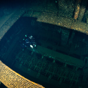 Rebreather diver seen from above in an open cargo hold, Red Sea, Egypt
