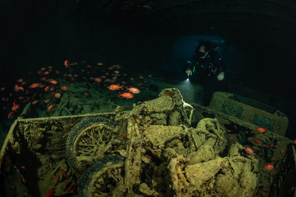 Motorcycles in a truck bed lit by a diver’s torch in a hold, Thistlegorm wreck, Red Sea, Egypt