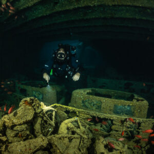 Rebreather diver behind a truck loaded with motorcycles and soldierfish, Thistlegorm wreck, Red Sea, Egypt