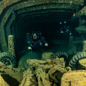 Rebreather diver facing the camera among tyres and cargo in a hold, Thistlegorm wreck, Red Sea, Egypt