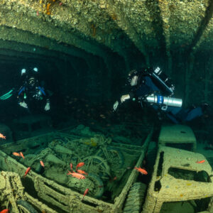 Two rebreather divers above trucks loaded with motorcycles, Thistlegorm wreck, Red Sea, Egypt