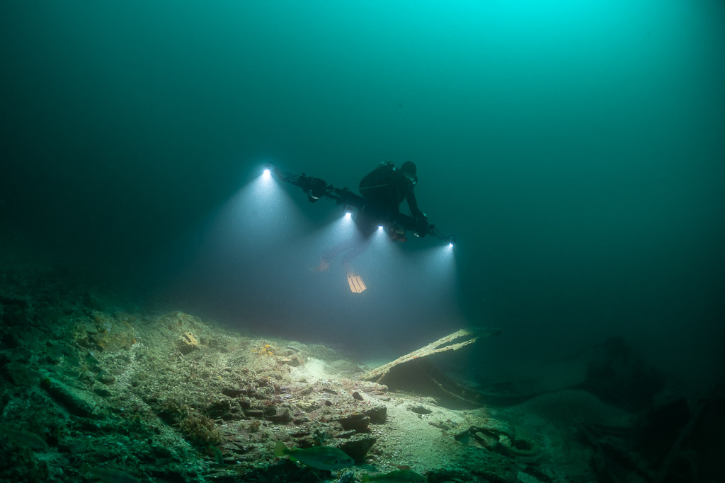 Photogrammetry rig with four lights sweeping over scattered wreck debris, Saint-Malo, Brittany, France