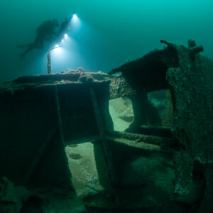 Diver above an open wreck structure seen through its frames, Saint-Malo, Brittany, France
