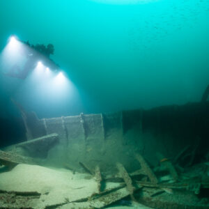 Photogrammetry lights illuminating wreck frames near a curved hull section, Saint-Malo, Brittany, France