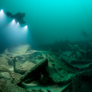 Diver with photogrammetry rig over wide field of scattered wreck plates, Saint-Malo, Brittany, France