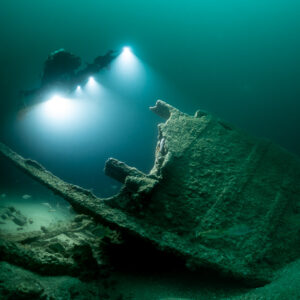 Photogrammetry lights over a tilted broken wreck section on the sand, Saint-Malo, Brittany, France