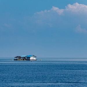 Small floating hut on a calm blue sea, Shark Point, Banda Sea, Indonesia
