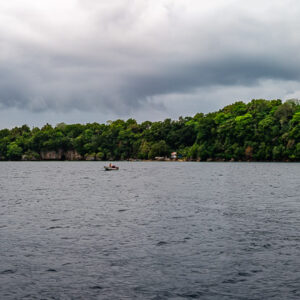 Small forested island on a grey sea under overcast sky, Banda Islands, Banda Sea, Indonesia