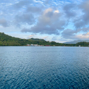 Panorama of a calm bay and green island seen from the boat, Banda Islands, Banda Sea, Indonesia