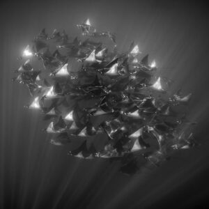 Black-and-white image of a compact mobula ray school, vertical framing, Baja California Sur, Mexico