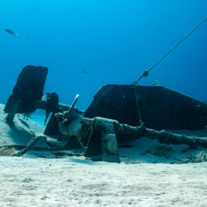 Stern of a broken wreck with rudder, shaft and mooring line on sand, Grand Bahama, Bahamas