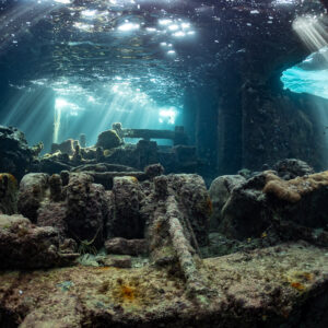 Sunbeams piercing the broken deck of a shallow concrete wreck, SS Sapona wreck, Bimini, Bahamas