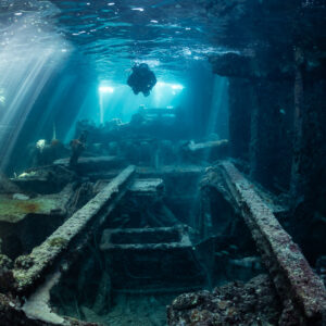 Long view through a wreck interior with diver silhouette in the distance, SS Sapona wreck, Bimini, Bahamas