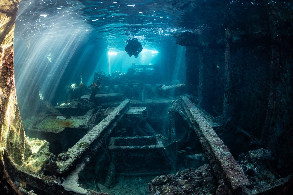 Long view through a wreck interior with diver silhouette in the distance, SS Sapona wreck, Bimini, Bahamas