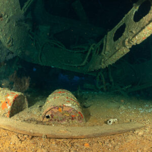 Barrels and a curved beam on the sandy floor of a wreck hold, Levanzo wreck, Red Sea, Egypt