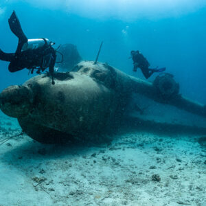 Diver upside down over the nose of a seaplane wreck, Grumman HU-16 Albatross wreck, Red Sea, Egypt