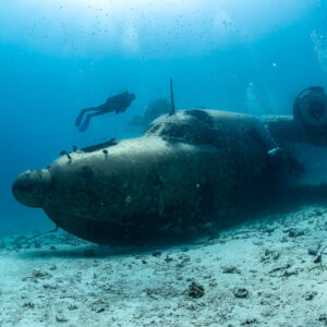 Two divers flanking the fuselage of a seaplane wreck, Grumman HU-16 Albatross wreck, Red Sea, Egypt