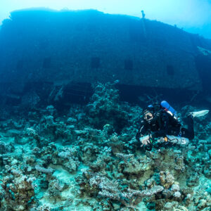 Rebreather diver in front of the wreck superstructure with windows, Al Kahfain wreck, Red Sea, Egypt