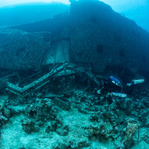 Diver along collapsed wreckage at the foot of the hull, Al Kahfain wreck, Red Sea, Egypt