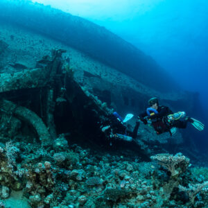 Two divers exploring the collapsed wreck section, wide view, Al Kahfain wreck, Red Sea, Egypt
