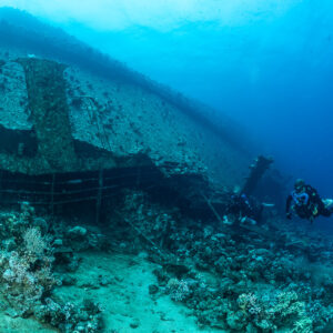 Rebreather divers along the wreck stern area, Al Kahfain wreck, Red Sea, Egypt