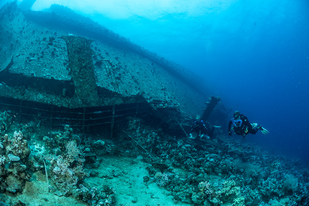Rebreather divers along the wreck stern area, Al Kahfain wreck, Red Sea, Egypt