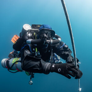 Rebreather diver with stage cylinders holding the ascent line in blue water, Chalutier à Benoît wreck (Lacanau), Gironde, France